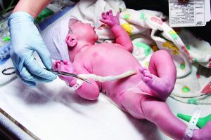 Newborn cute infant baby with umbilical cord